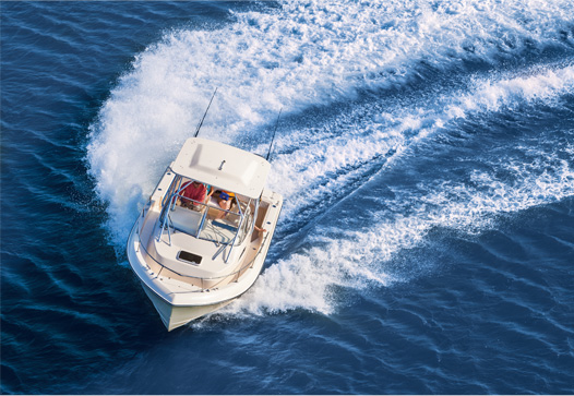 The Grady-White Gulfstream 232 walkaround cabin boat making a turn on the water