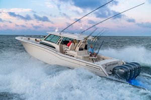 Grady-White Canyon 456 45-foot center console fishing boat running at sunrise