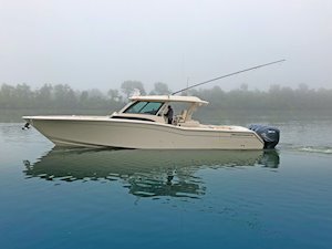 Grady-White Canyon 456 45-foot center console fishing boat running on misty calm water