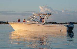 Grady-White Freedom 275 27-foot dual console boat port side with family at sunrise