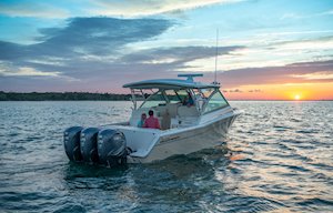 Grady-White Freedom 375 37-foot dual console fishing boat cruising at sunset