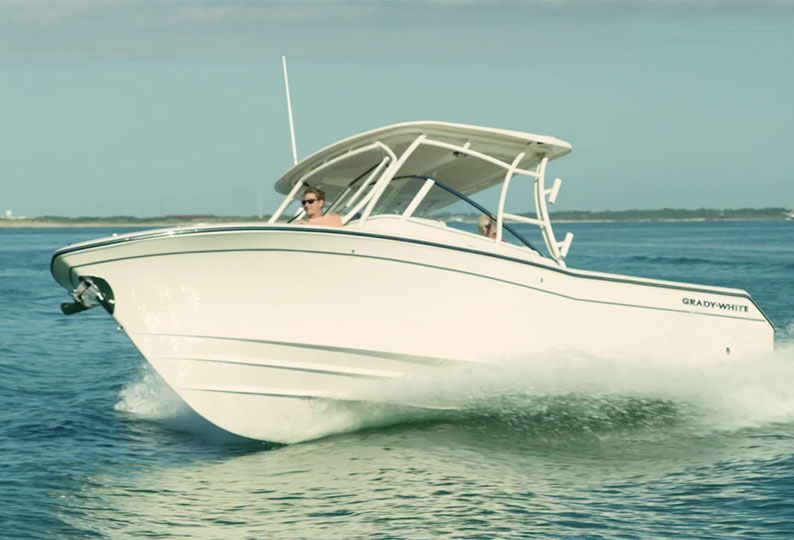 A dual console Grady-White boat making a turn, showing off the SeaV2 hull of the boat