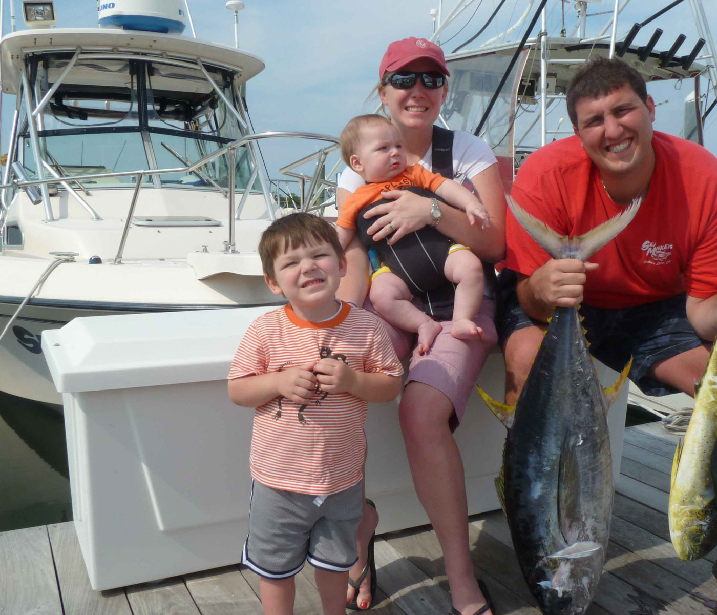Family posing with fish