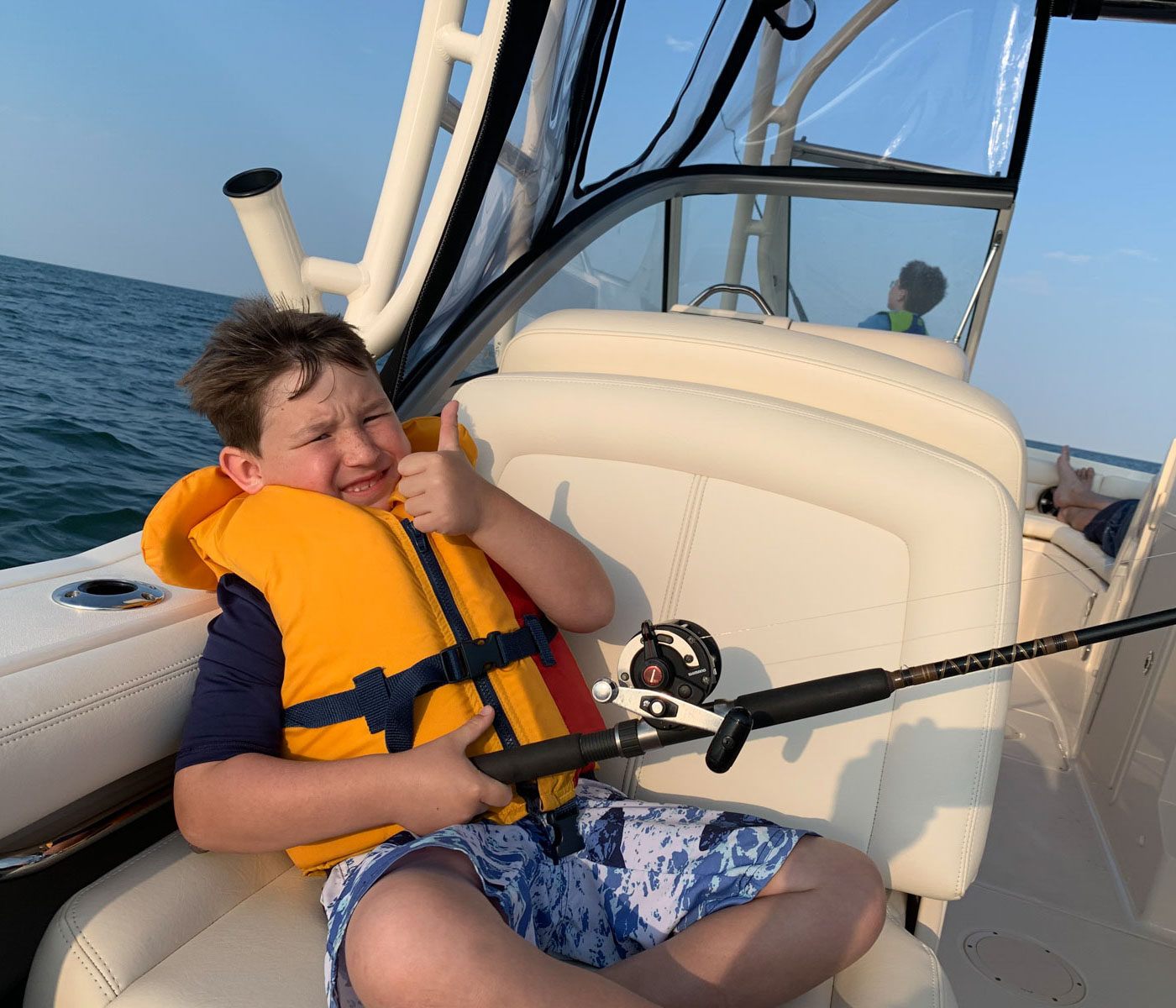 Boy in boat with fishing rod