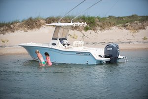 Grady-White Fisherman 236 23-foot center console family in water by beach
