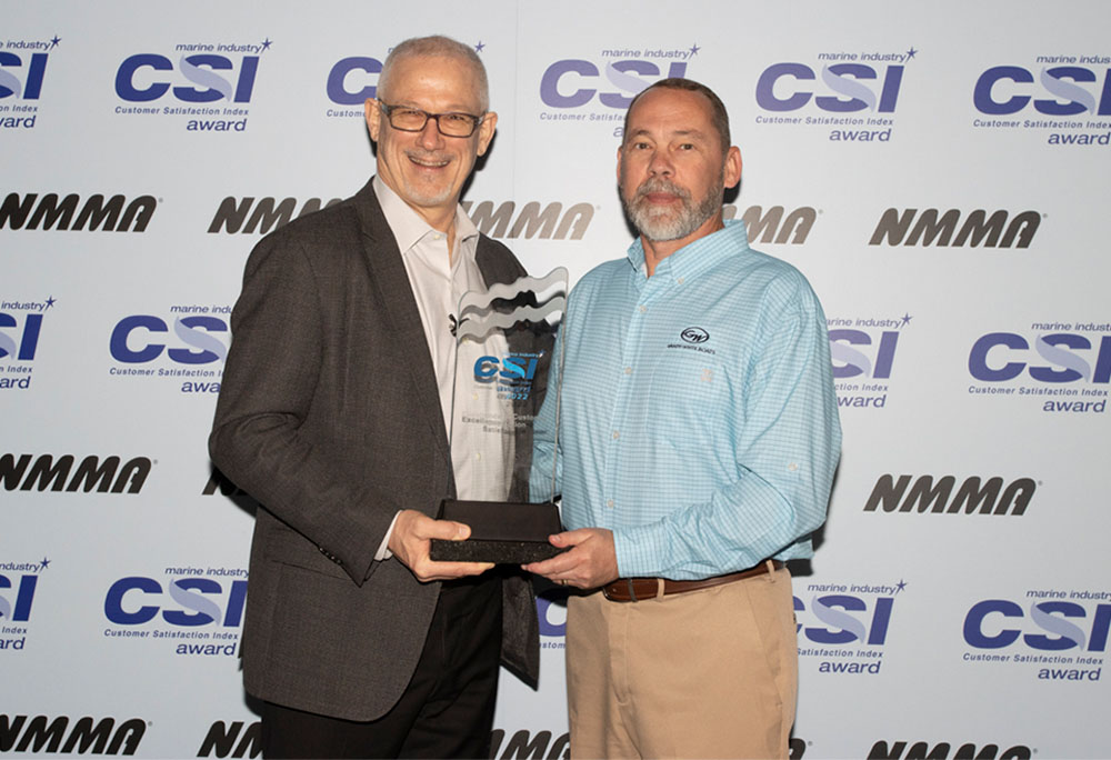 Todd Leggett, Grady-White Boats, Dealer/Customer Relations Manager (r) accepts the National Marine Manufacturers Association Customer Satisfaction Index award from the association's President, Frank Hugelmeyer.
