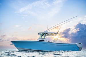 Grady-White Canyon 306 30-foot center console boat port side with beautiful sky background