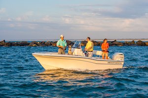 Grady-White Fisherman 180 18-foot center console friends with dog by jetty