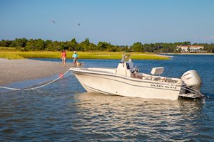 Grady-White Fisherman 180 18-foot center console at anchor at sandbar couple on beach