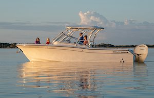 Grady-White Freedom 275 27-foot dual console boat port side with family at sunrise