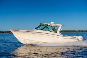 Grady-White Freedom 345 dual console boat running portside on a clear day