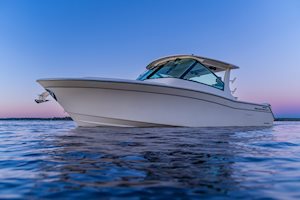 Grady-White Freedom 345 dual console boat on the water at sunset, port side