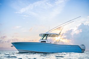 Grady-White Canyon 306 30-foot center console boat port side with beautiful sky background