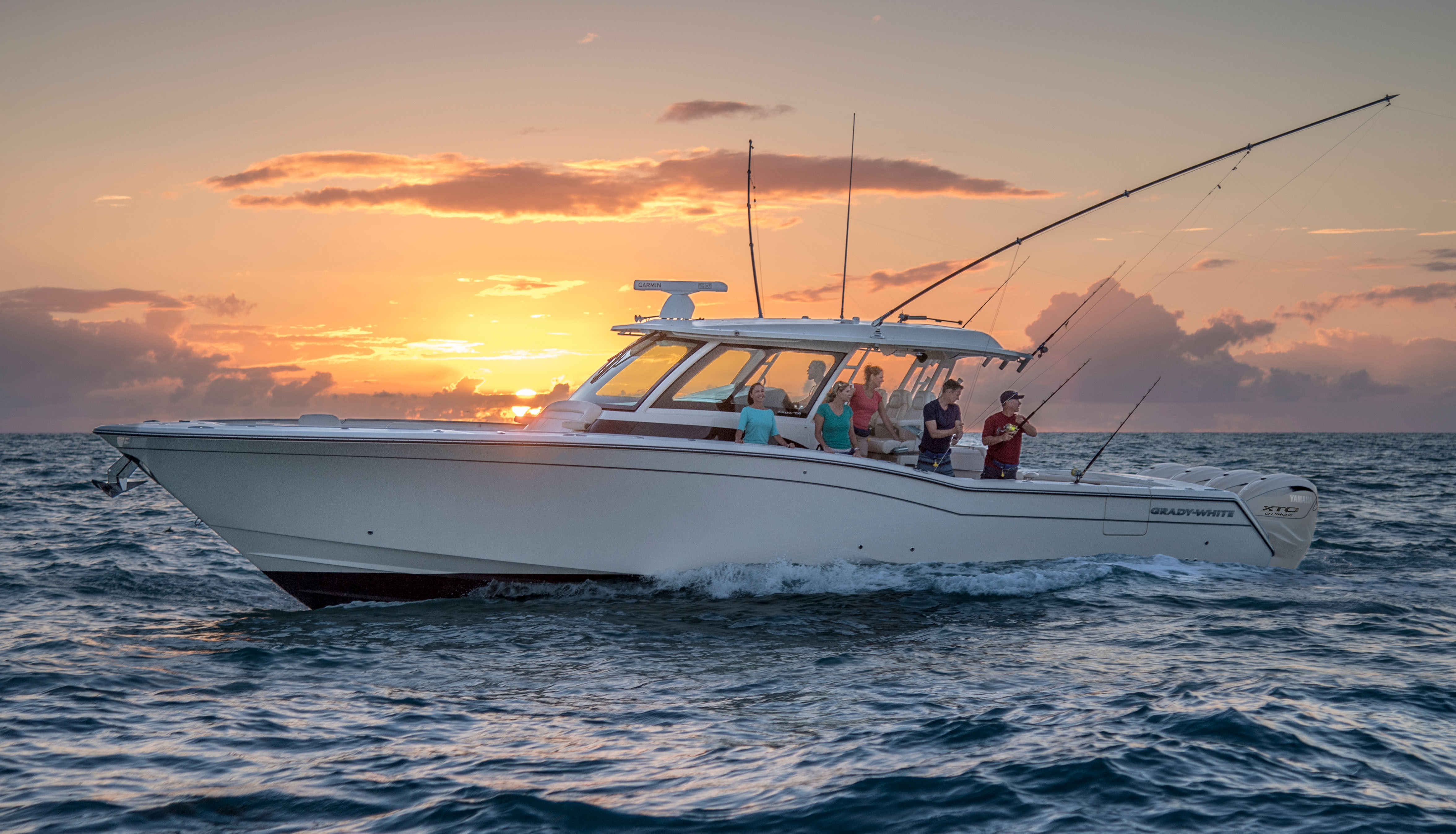 Grady-White Canyon 456 center console boat port side with people fishing from cockpit
