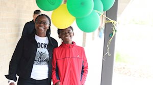 Two people posing with balloons