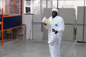Man smiling while holding popcorn and soda