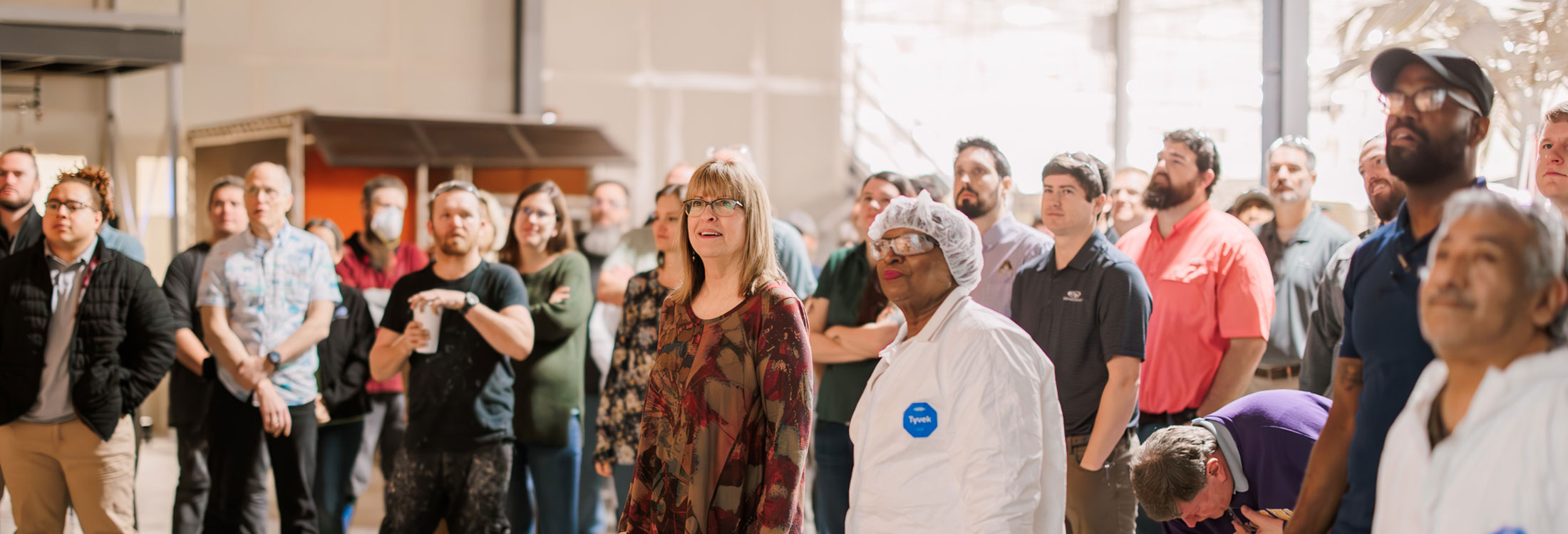 People gathered for presentation in factory
