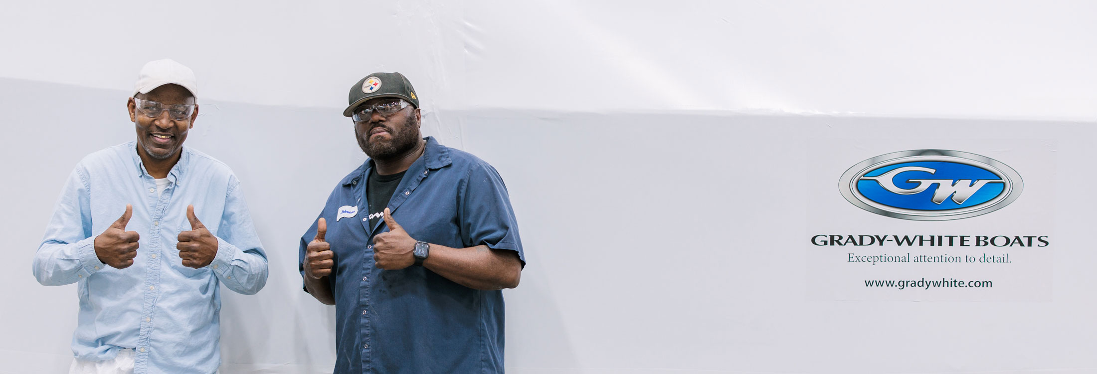 Two men giving the thumbs up