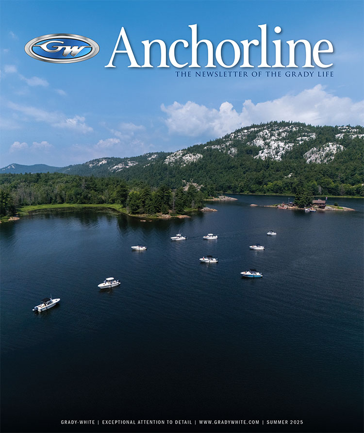 Front cover of Anchorline newsletter showing several Grady-White boats gathered near the shore of a beautiful wooded landscape with mountains and blue sky in background.