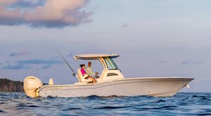 Grady White 281 CE cruising starboard near shoreline