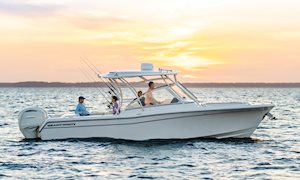 Grady-White Freedom 285 28-foot dual console starboard side cruising at sunset